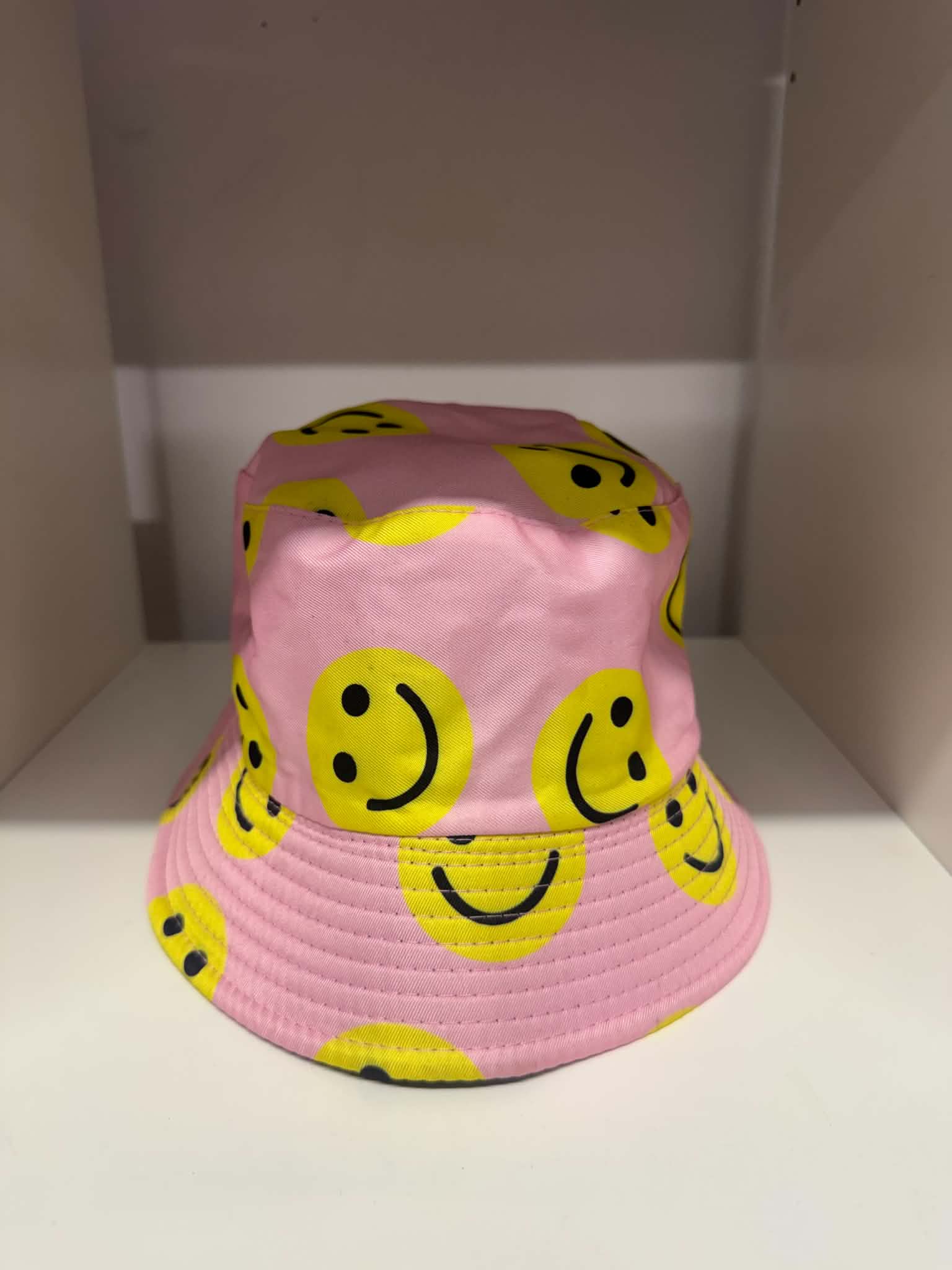 Pink all-over yellow smiley face bucket hat | Festival hats Belfast